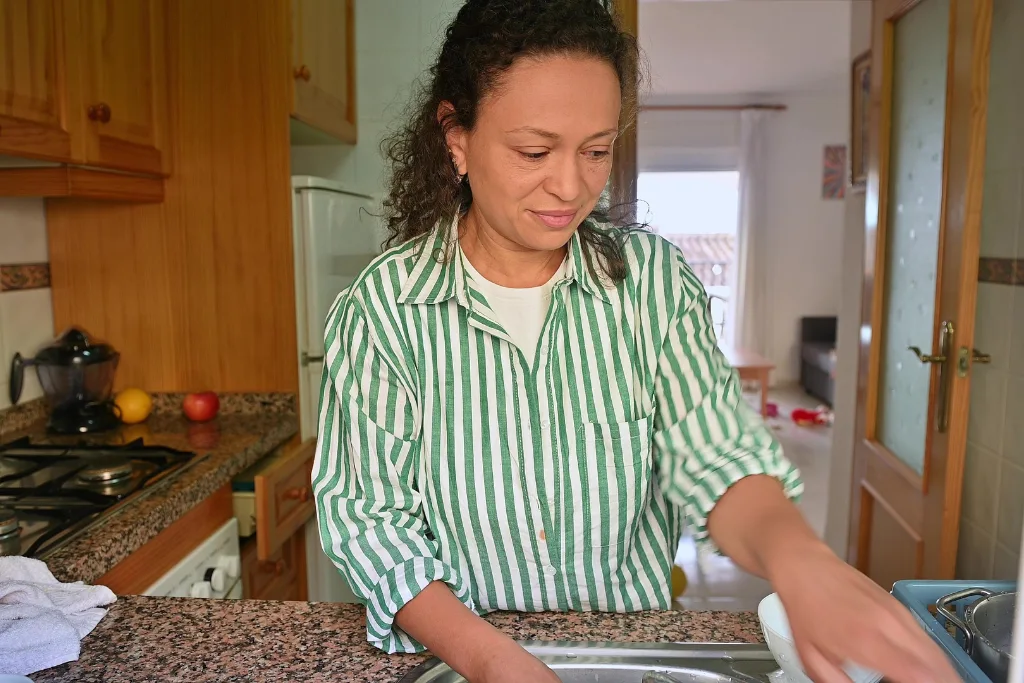 Female carer cleaning the kitchen