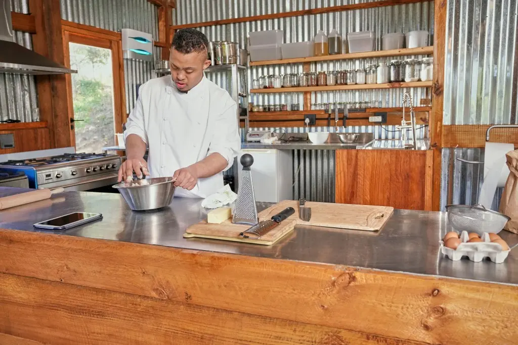 Young disabled man cooking in the kitchen