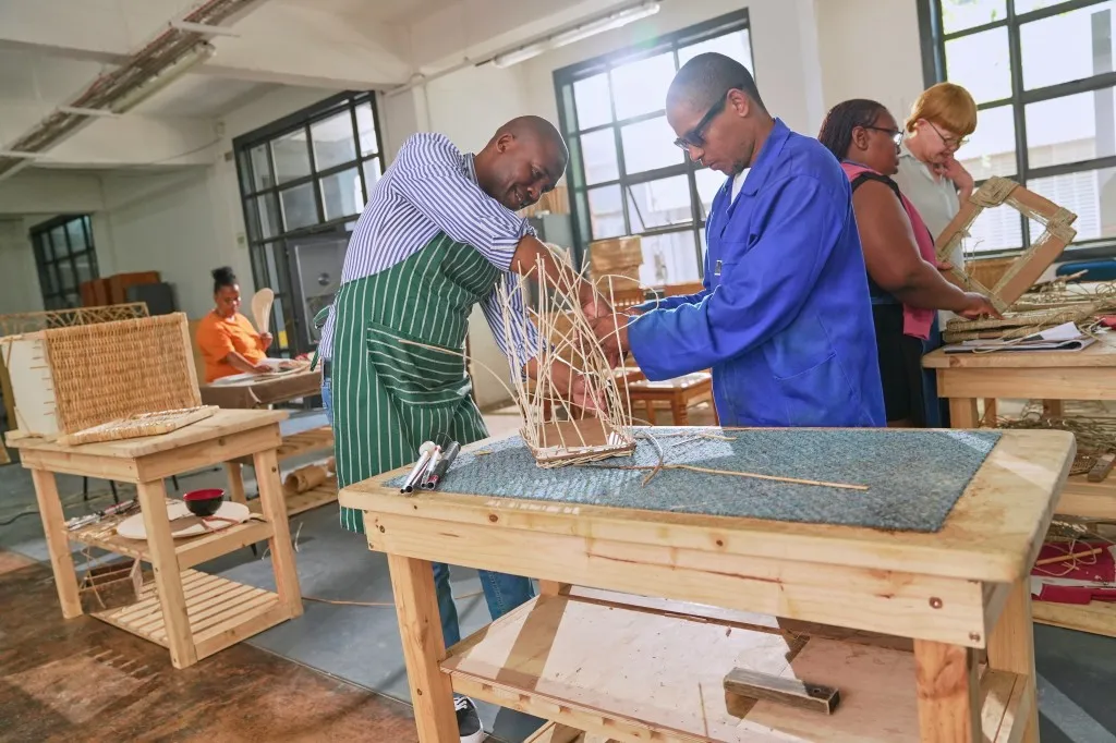 Two disabled men making arts and crafts on a table